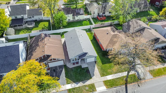 an aerial view of a house with a garden and large trees