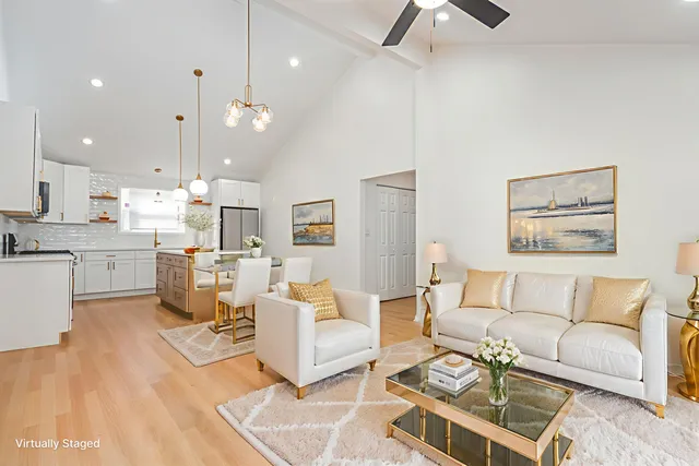 a living room with furniture and kitchen view
