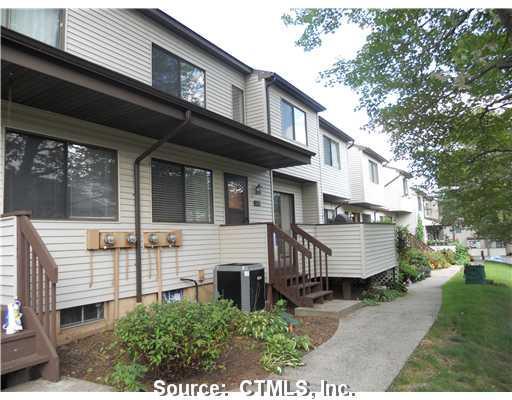 635 Cypress Road, Unit 635 Newington, CT 06111 - Photo 1 of 1 a front view of a house with a garden