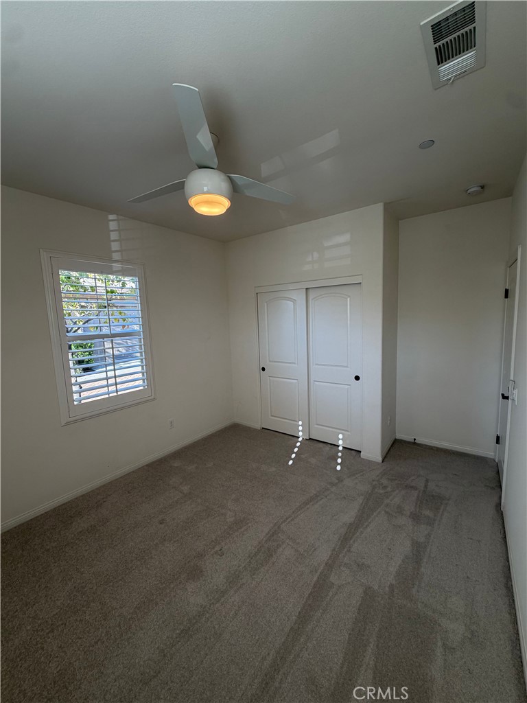 15 Galan Street Rancho Mission Viejo, CA 92694 - Photo 14 of 24 an empty room with a ceiling fan and window