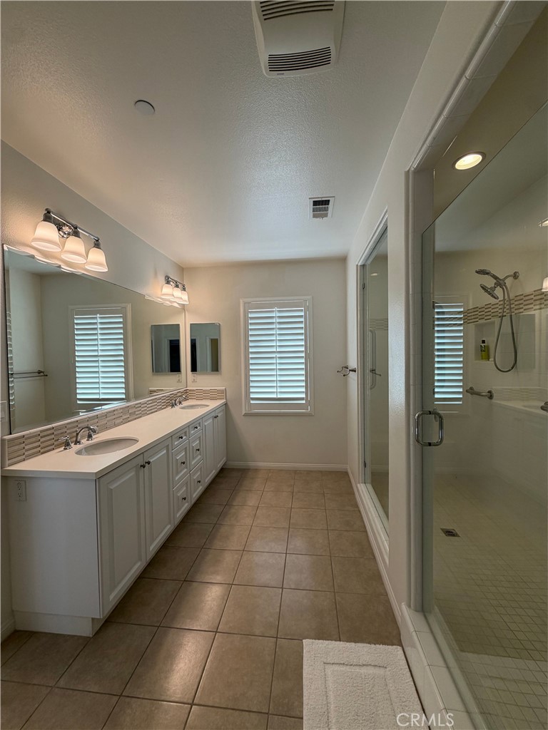 15 Galan Street Rancho Mission Viejo, CA 92694 - Photo 17 of 24 a large bathroom with a tub a sink shower and mirror