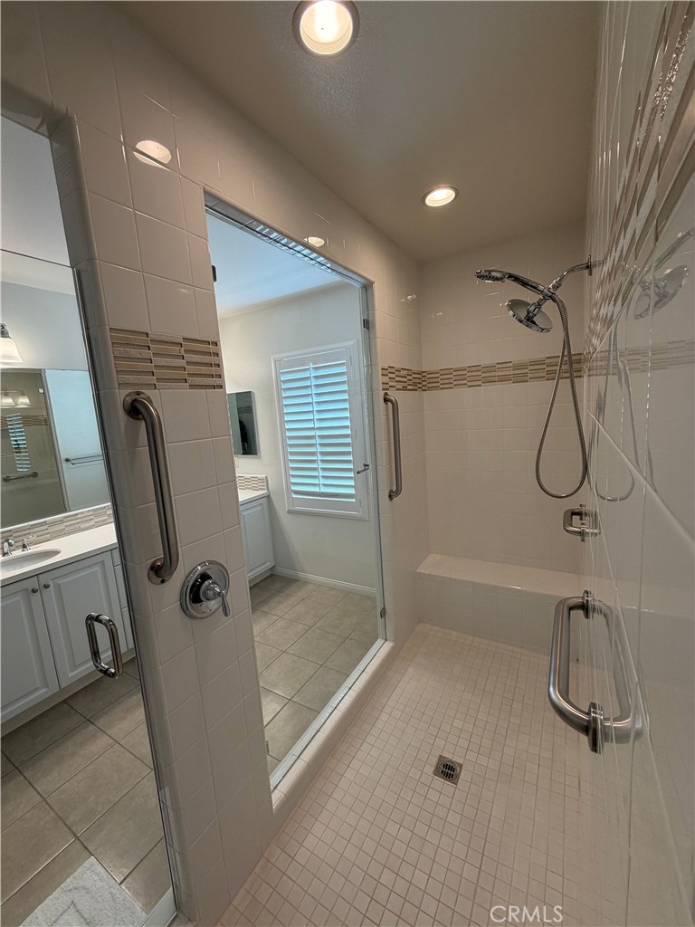 15 Galan Street Rancho Mission Viejo, CA 92694 - Photo 19 of 24 a bathroom with a shower and a glass door