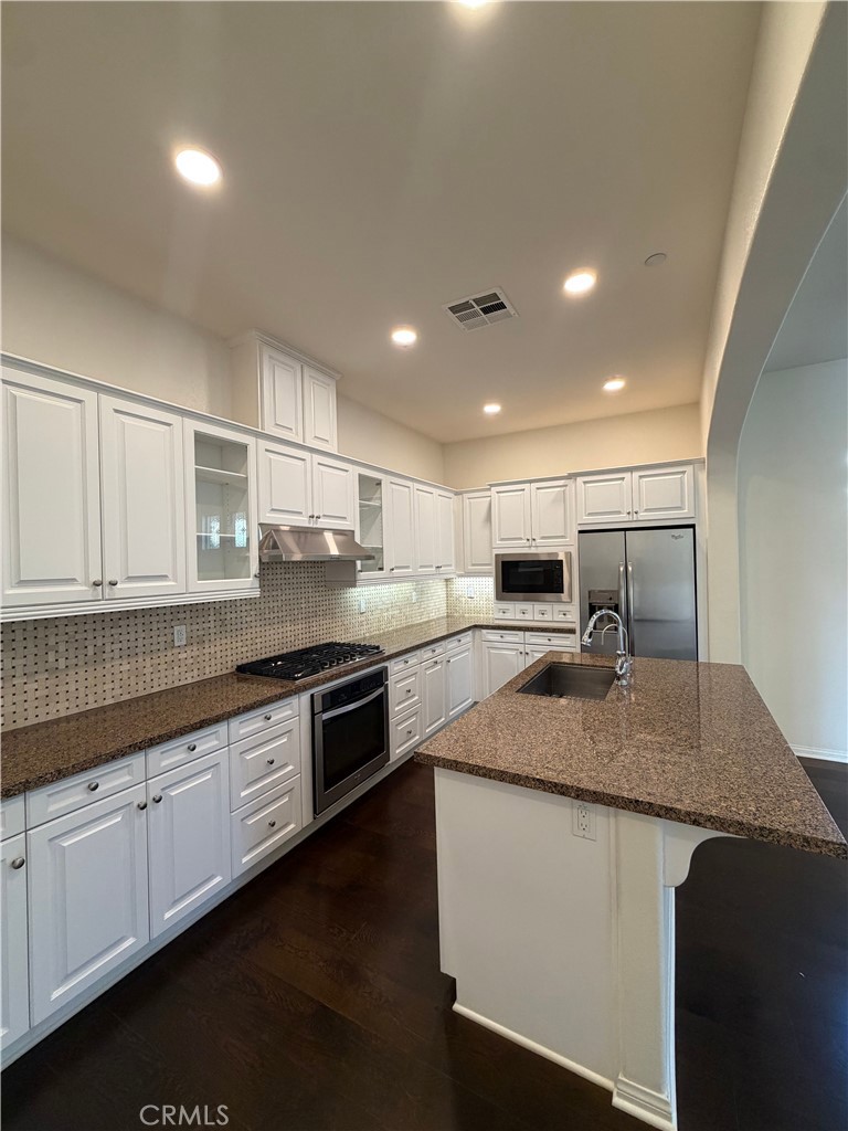 15 Galan Street Rancho Mission Viejo, CA 92694 - Photo 7 of 24 a kitchen with stainless steel appliances granite countertop a sink a stove and a refrigerator