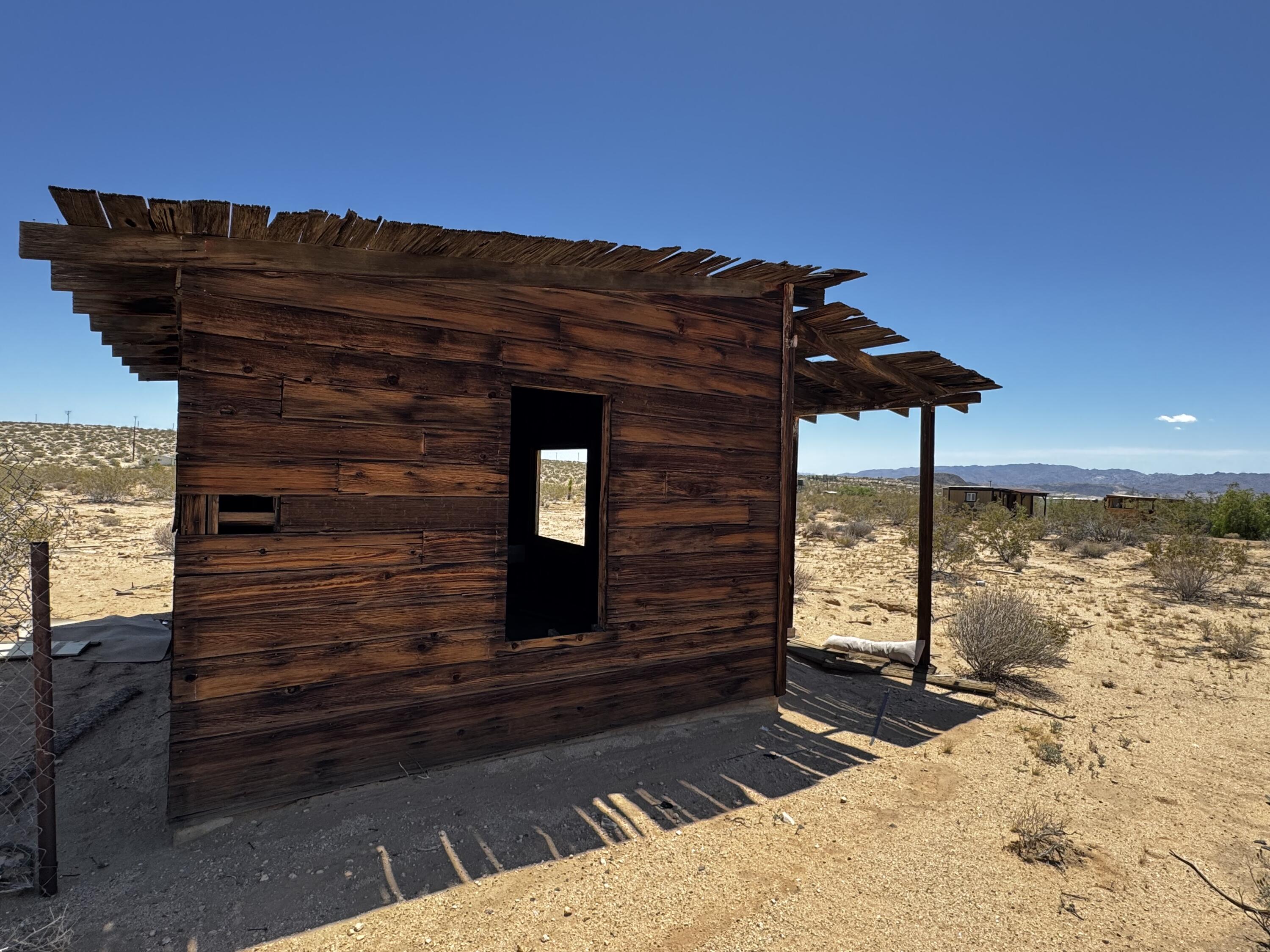 757 Mt Nebo Road Joshua Tree, CA 92252 - Photo 15 of 17 a view of a house with wooden fence