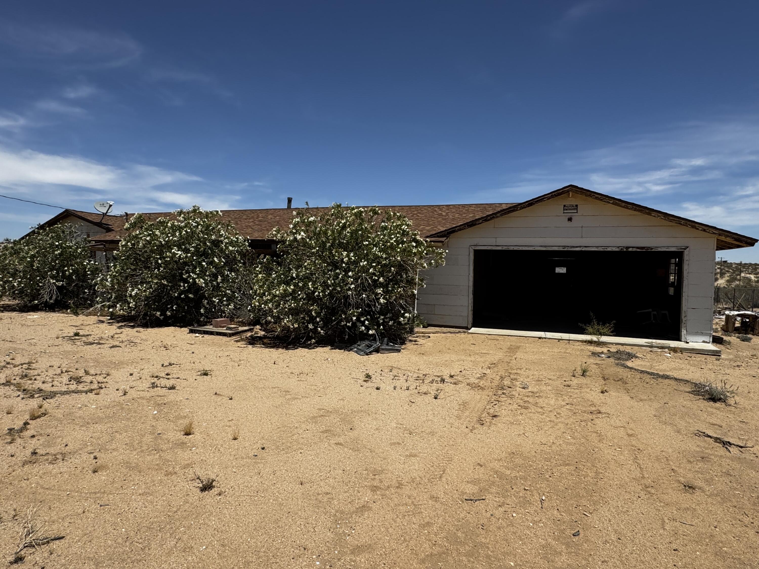757 Mt Nebo Road Joshua Tree, CA 92252 - Photo 2 of 17 a front view of a house with a yard covered in snow