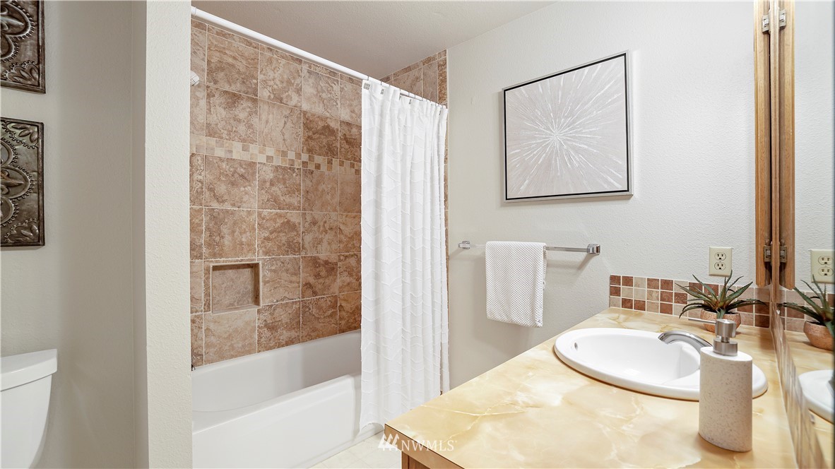 14101 148th Place Southeast Renton, WA 98059 - Photo 19 of 36 a bathroom with a sink toilet and shower