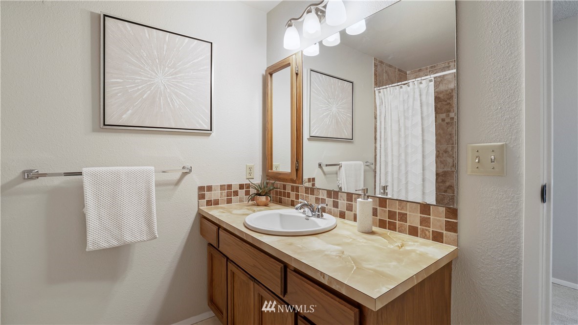 14101 148th Place Southeast Renton, WA 98059 - Photo 20 of 36 a bathroom with a sink vanity and a mirror