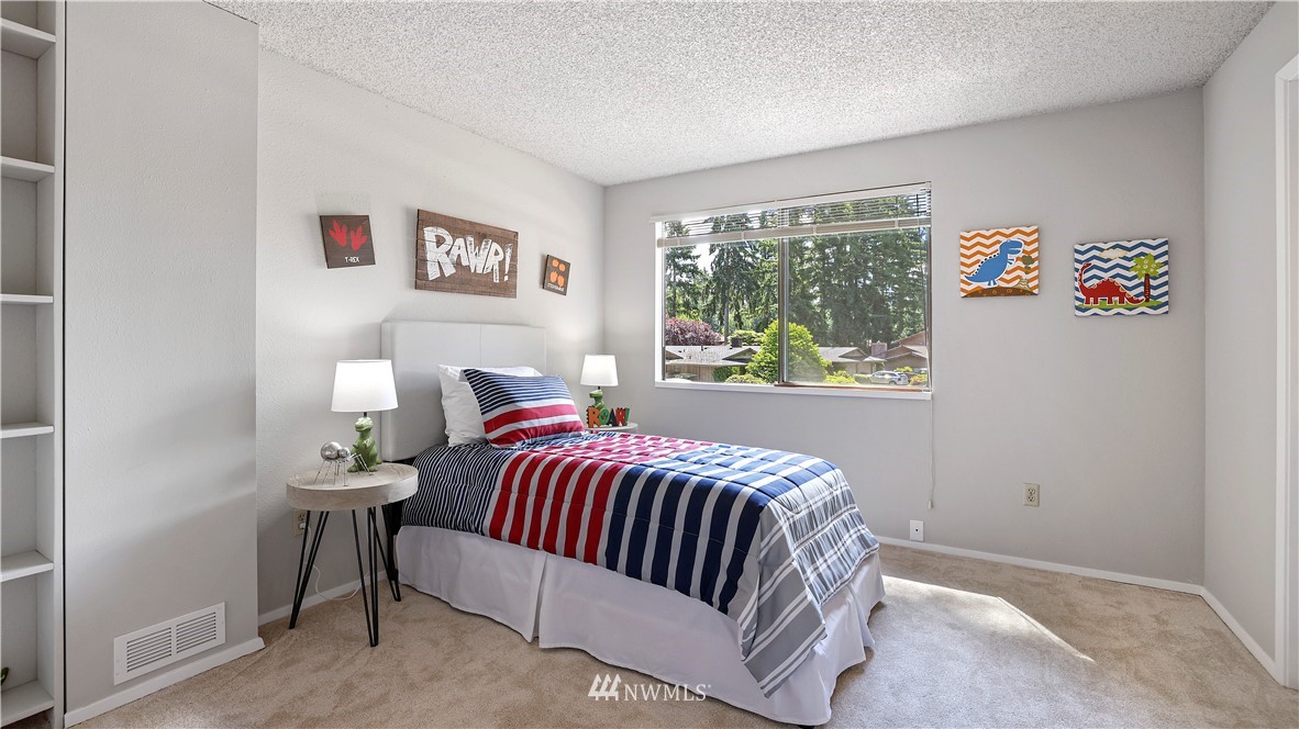 14101 148th Place Southeast Renton, WA 98059 - Photo 22 of 36 a bedroom with a bed and a window