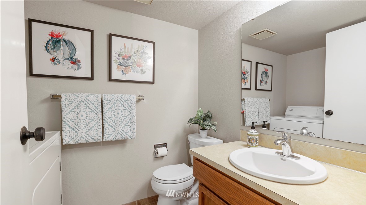 14101 148th Place Southeast Renton, WA 98059 - Photo 26 of 36 a bathroom with a toilet sink and mirror