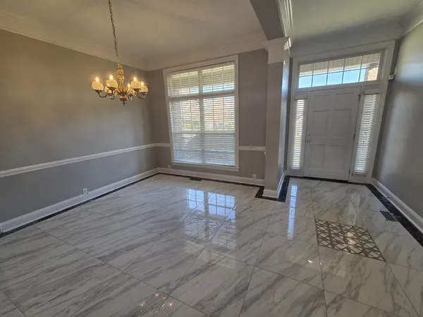 a view of a livingroom with wooden floor and a large window