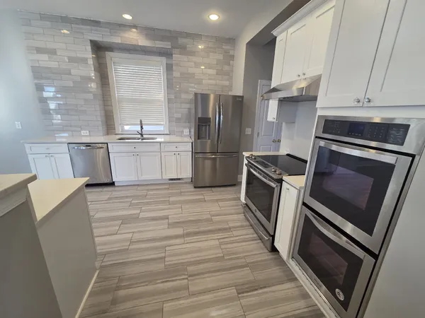a kitchen with a sink cabinets and stainless steel appliances