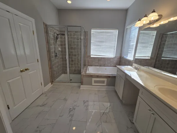 a spacious bathroom with a granite countertop sink a toilet and shower