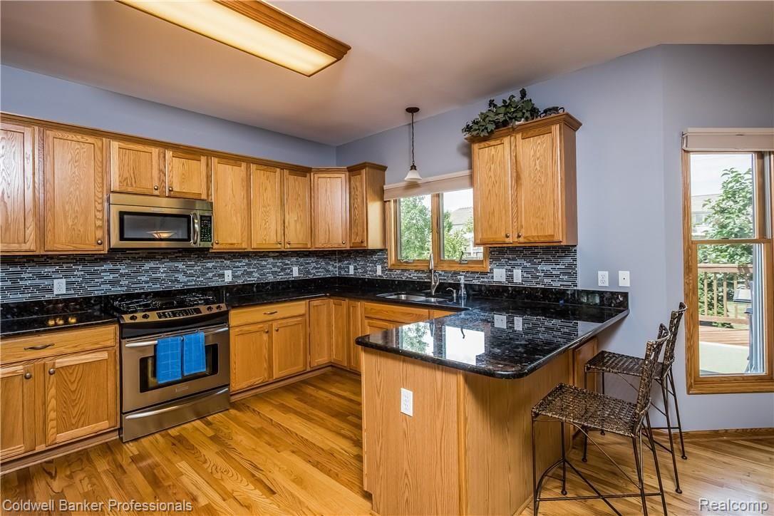 8483 Lee Road Brighton, MI 48116 - Photo 17 of 41 Counter extended to make a breakfast bar for quick meals