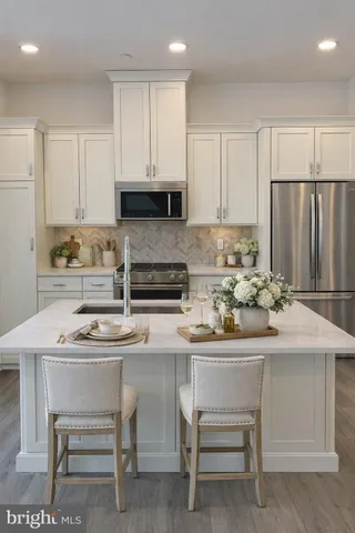 a kitchen with a sink cabinets and wooden floor