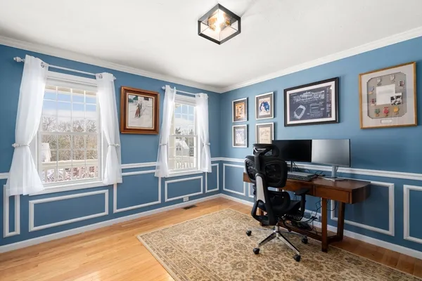 a view of a workspace with furniture and a window