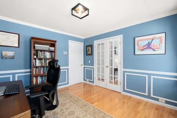 a bedroom with bed tv and a window