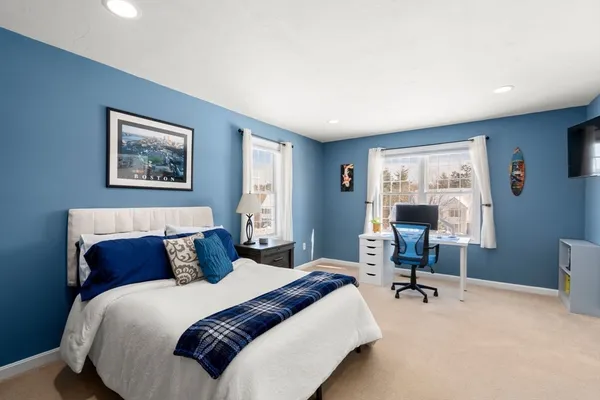 a bedroom with a bed and a television