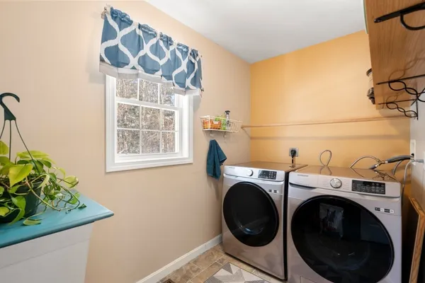 a bathroom with a granite countertop sink mirror vanity and toilet