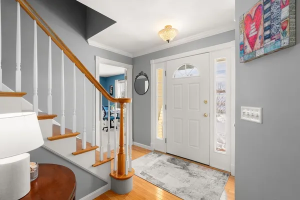 a view of a hallway with furniture and staircase