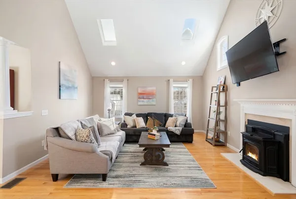 a living room with furniture a flat screen tv and a fireplace