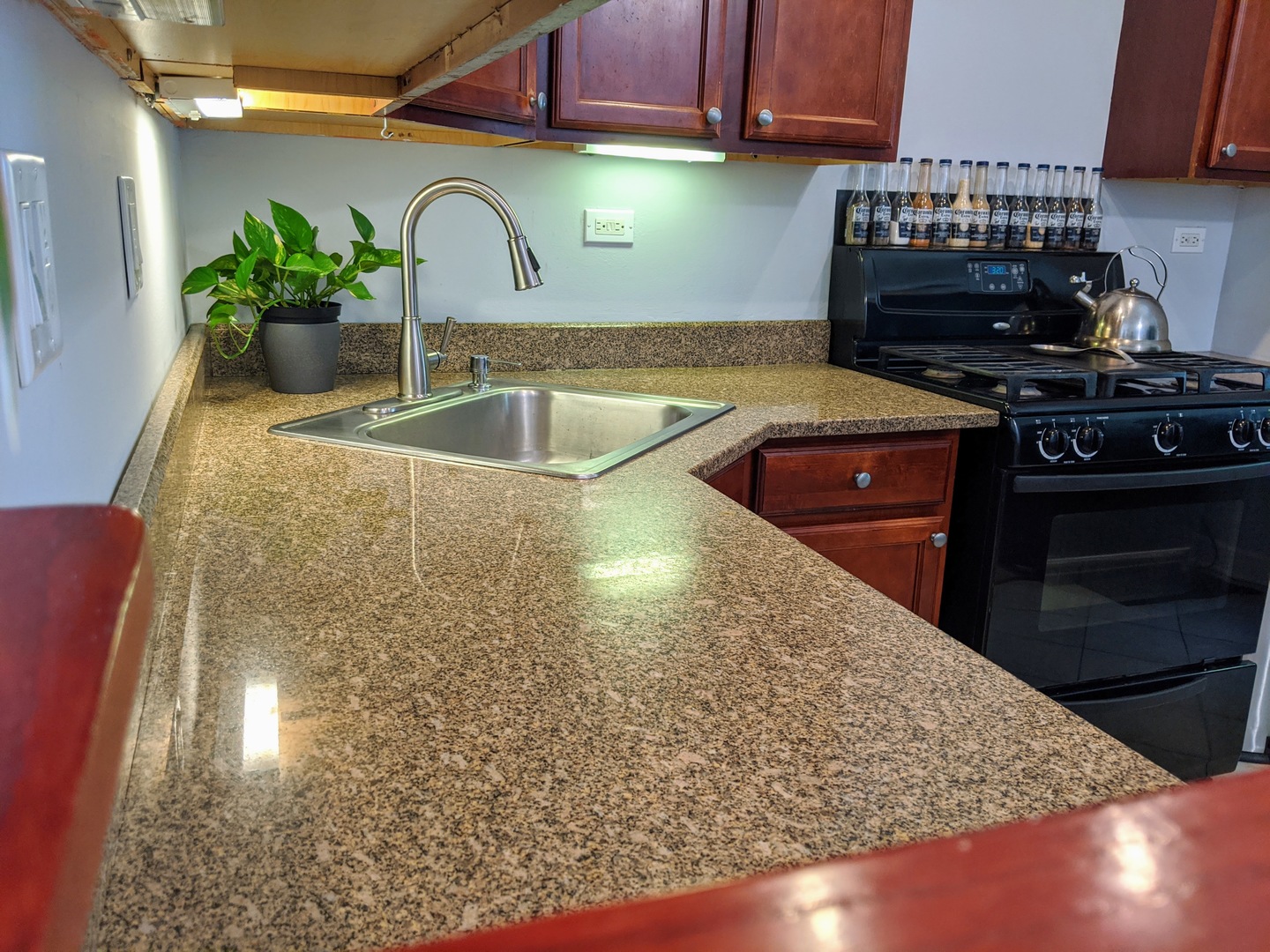 14 East Oltendorf Road Streamwood, IL 60107 - Photo 5 of 21 a kitchen with granite countertop a sink a stove and cabinets