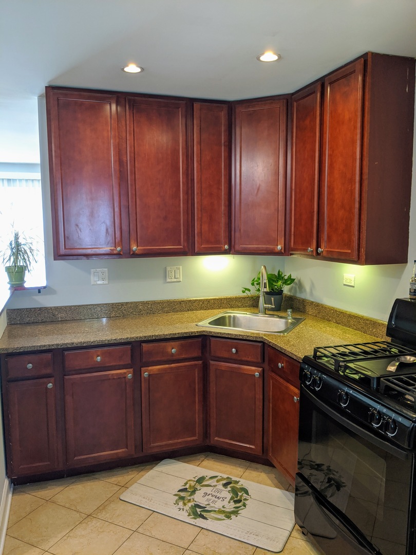 14 East Oltendorf Road Streamwood, IL 60107 - Photo 6 of 21 a kitchen with wooden cabinets and a stove top oven