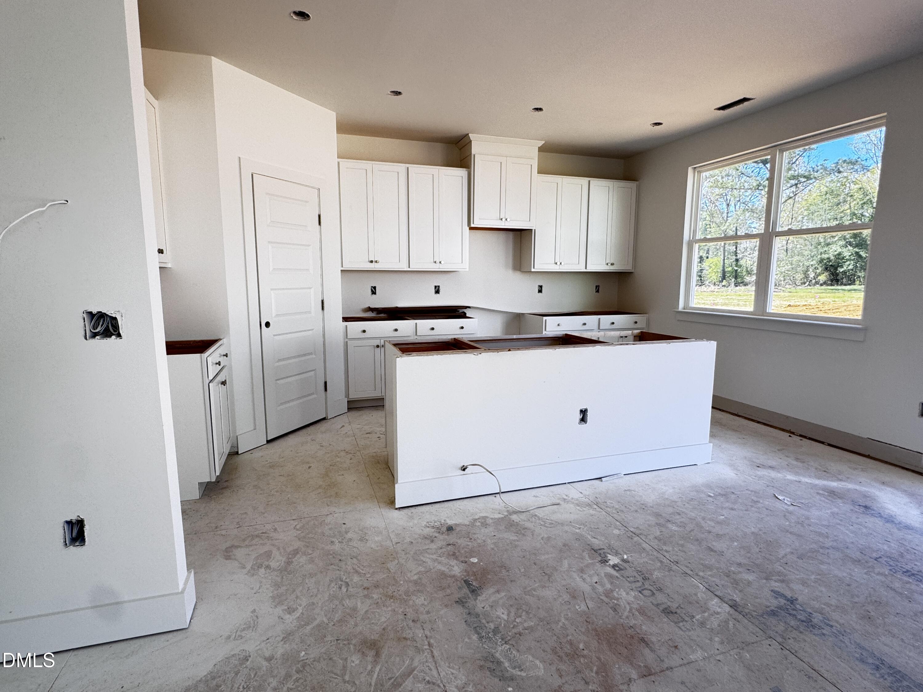 263 Kindness Drive Lillington, NC 27546 - Photo 11 of 37 a kitchen with white cabinets and white appliances