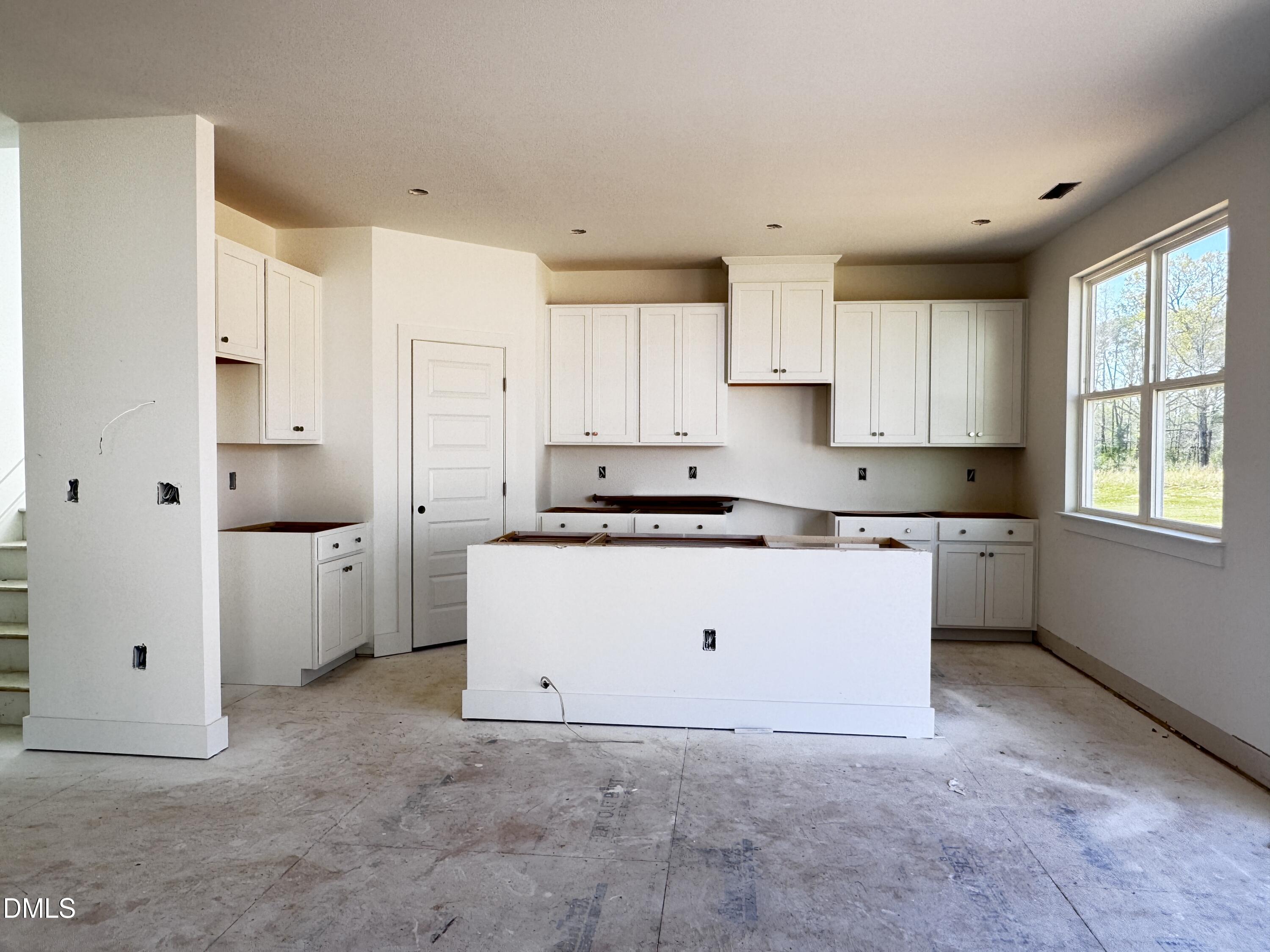 263 Kindness Drive Lillington, NC 27546 - Photo 14 of 37 a kitchen with cabinets appliances a sink and a window