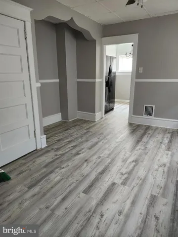 an empty room with wooden floor and closet