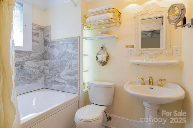 a bathroom with a sink a toilet and bathtub