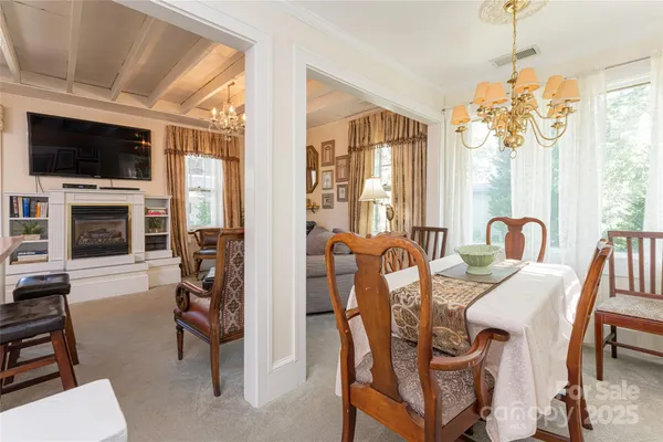 a view of a dining room with furniture window and a fireplace