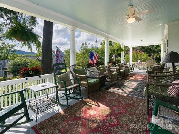 a living room with patio furniture and a floor to ceiling window