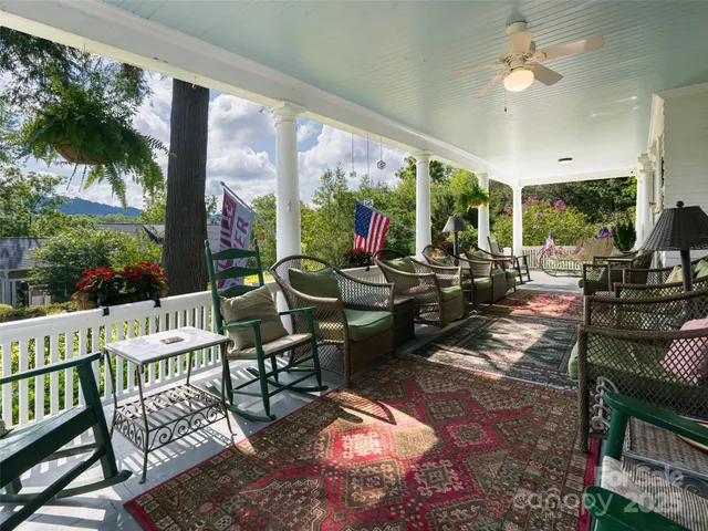 a living room with patio furniture and a floor to ceiling window