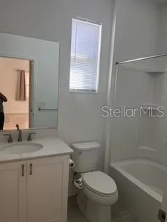 a bathroom with a double vanity sink and mirror