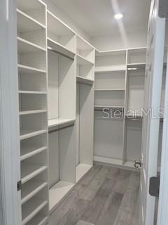 7947 Southwest 89th Loop Ocala, FL 34476 - Photo 18 of 25 a view of walk in closet with empty racks