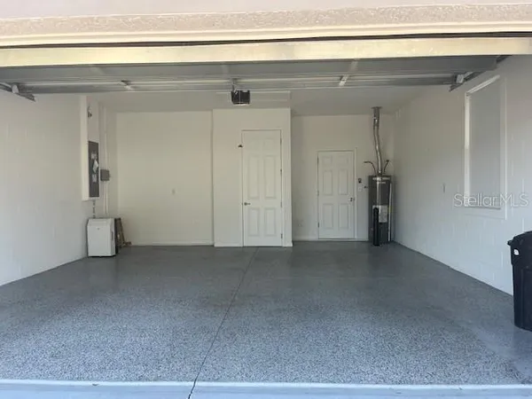 a view of a backyard with plants and outdoor seating
