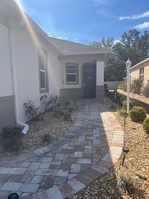 7947 Southwest 89th Loop Ocala, FL 34476 - Photo 3 of 25 a view of a backyard with plants and outdoor seating