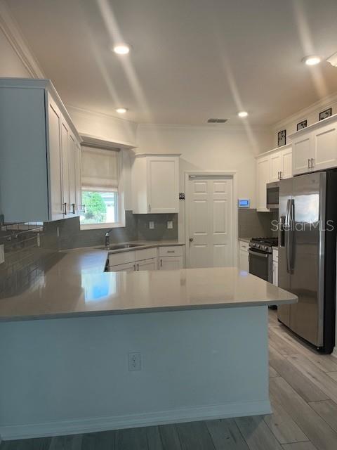 7947 Southwest 89th Loop Ocala, FL 34476 - Photo 7 of 25 a large kitchen with stainless steel appliances a large counter top a stove and a refrigerator