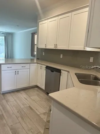 a view of a kitchen with a sink and a window