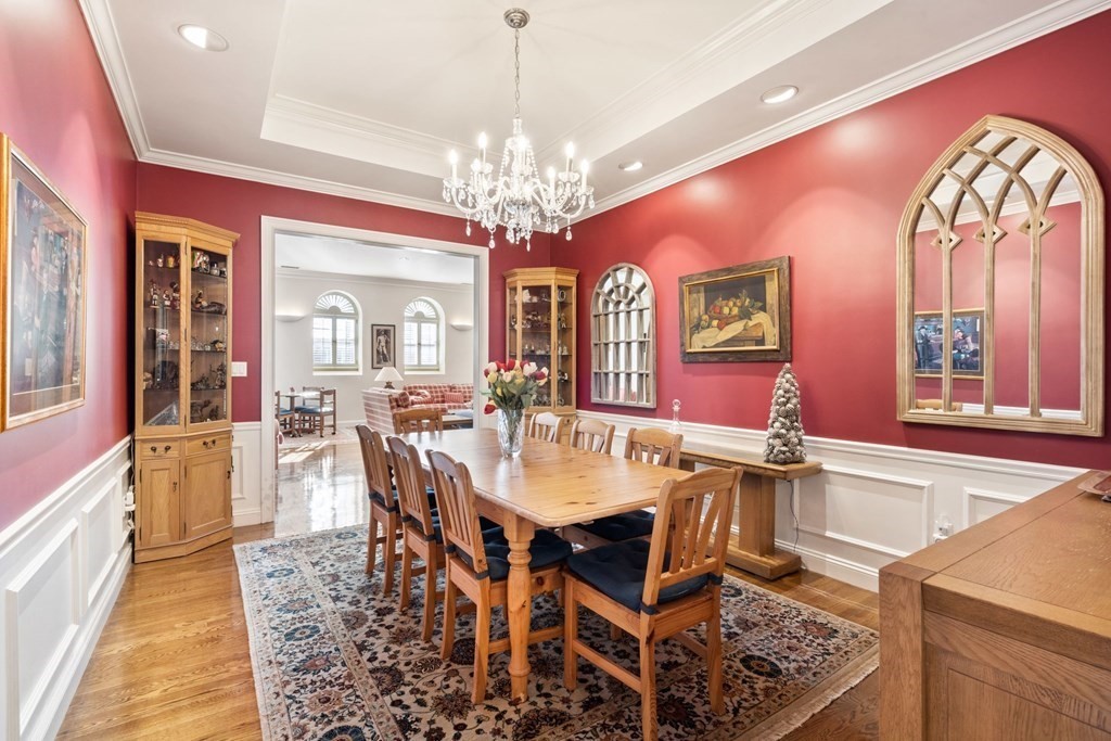 49 Rawson Road, Unit 49 Brookline, MA 02445 - Photo 11 of 42 a view of a dining room with furniture and a chandelier