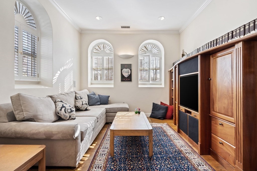 49 Rawson Road, Unit 49 Brookline, MA 02445 - Photo 15 of 42 a living room with furniture two wooden floor and a large window