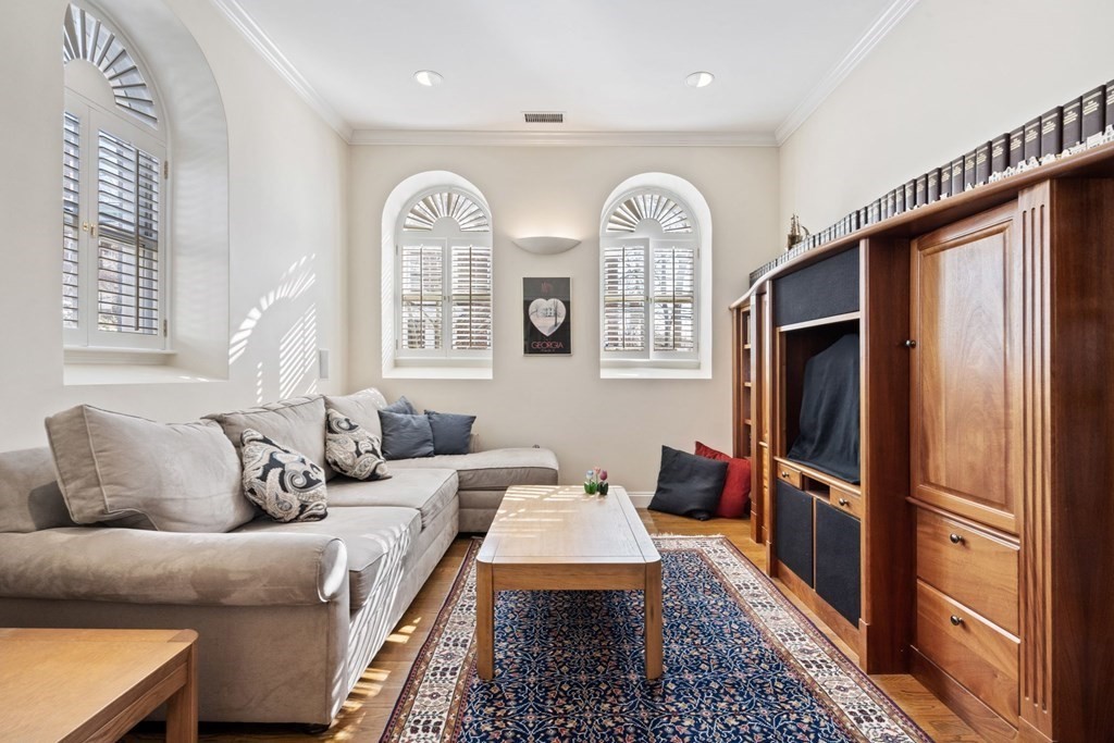 49 Rawson Road, Unit 49 Brookline, MA 02445 - Photo 16 of 42 a living room with furniture two wooden floor and a large window