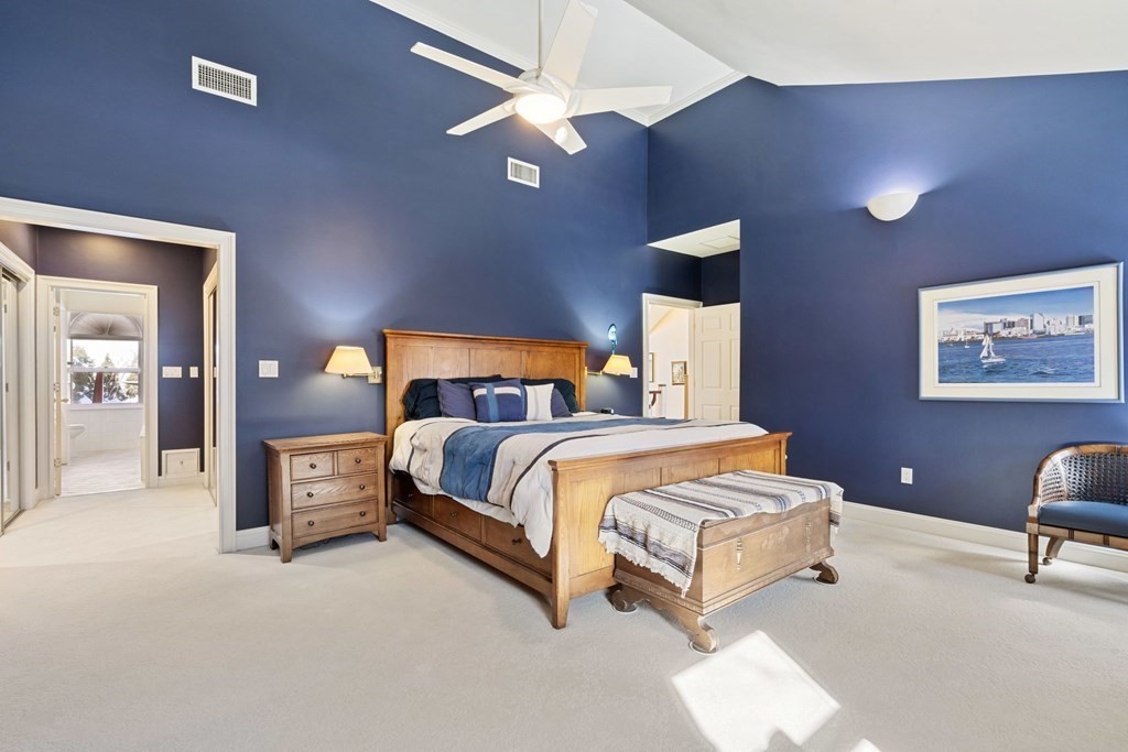 49 Rawson Road, Unit 49 Brookline, MA 02445 - Photo 19 of 42 a bedroom with a bed and a chandelier