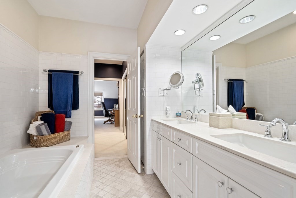 49 Rawson Road, Unit 49 Brookline, MA 02445 - Photo 22 of 42 a en suite bathroom with double vanity sink and a mirror