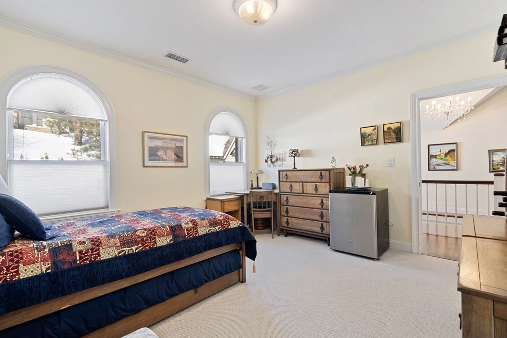 49 Rawson Road, Unit 49 Brookline, MA 02445 - Photo 23 of 42 a bedroom with furniture and a wooden floor