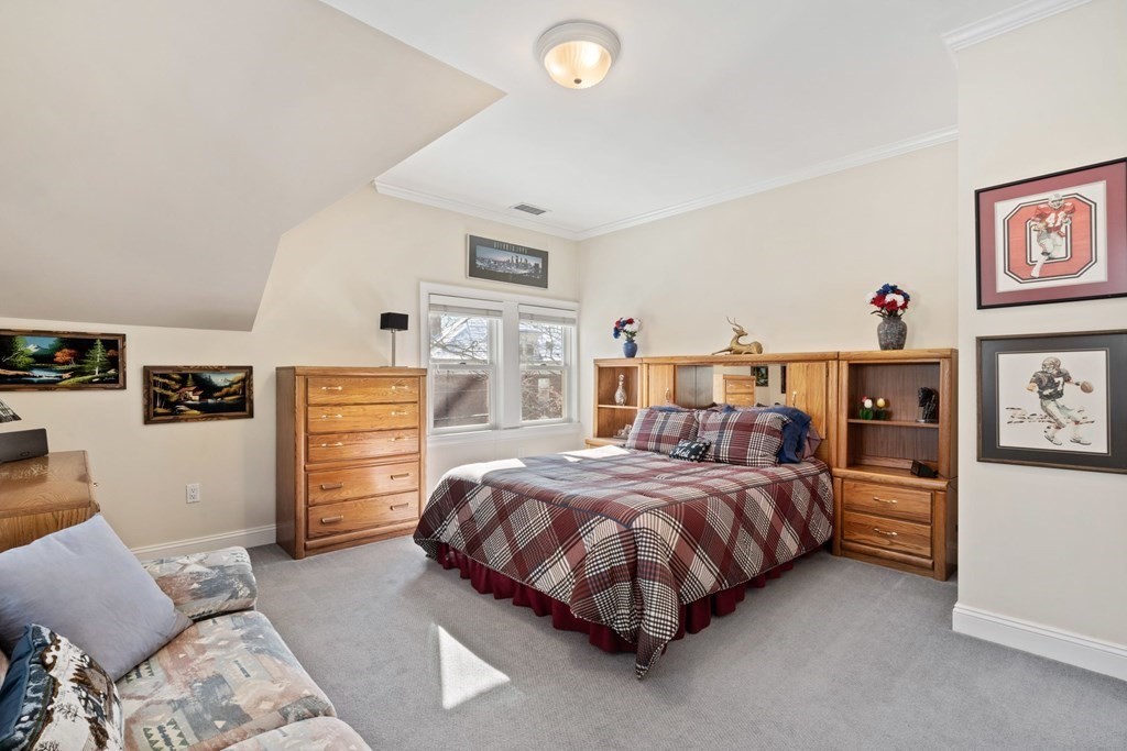 49 Rawson Road, Unit 49 Brookline, MA 02445 - Photo 25 of 42 a bedroom with a bed and cabinets