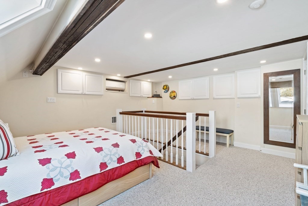 49 Rawson Road, Unit 49 Brookline, MA 02445 - Photo 27 of 42 a bedroom with a bed and cabinets