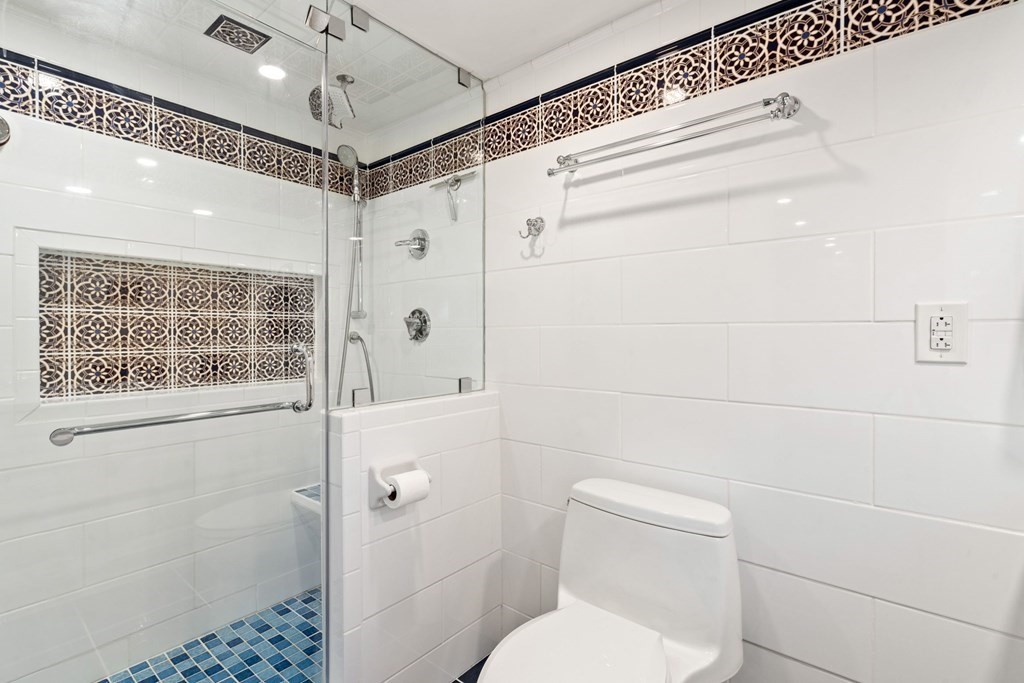 49 Rawson Road, Unit 49 Brookline, MA 02445 - Photo 28 of 42 a bathroom with a shower a toilet and a sink