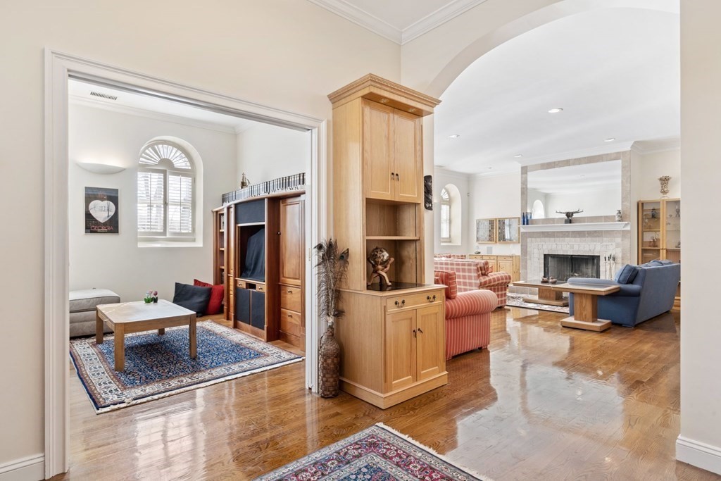 49 Rawson Road, Unit 49 Brookline, MA 02445 - Photo 5 of 42 a living room with furniture a fireplace and a flat screen tv