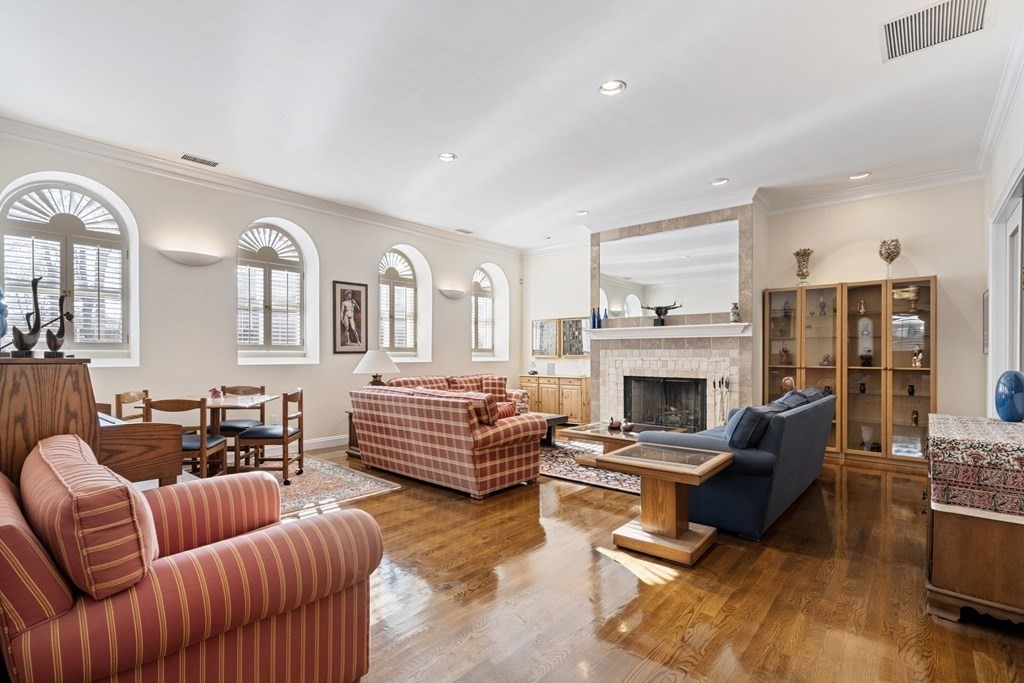 49 Rawson Road, Unit 49 Brookline, MA 02445 - Photo 6 of 42 a living room with furniture fireplace and a large window